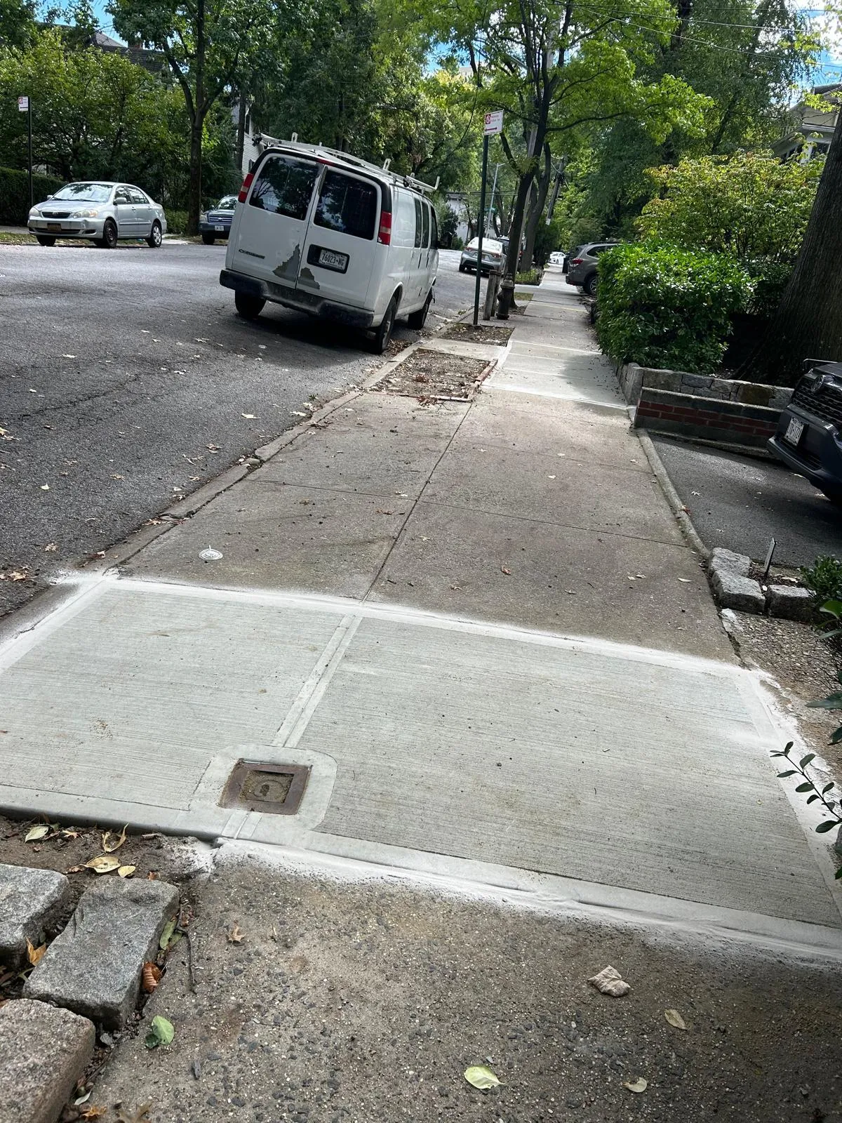 Level replacement sidewalk slabs at a brick home on Arlington Ave in the Bronx